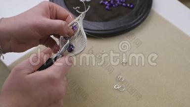 女工匠用金属线缝制，准备一件新珠宝